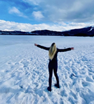 Young girl standing in snow on dream vacation